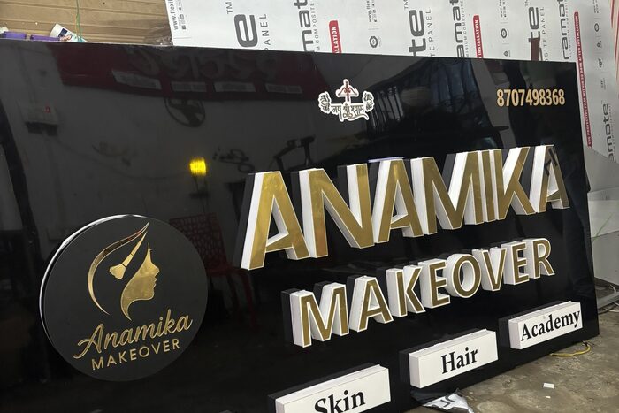 Illuminated LED logo and gold 3D letters on a black signboard, made by ALFA Signage